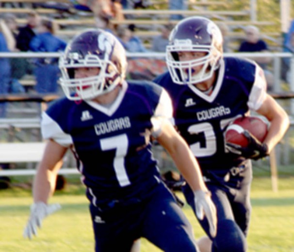 The Cougars' Jaden Penning carries the football and follows teammate Brody Roder (7) on a sweep play during a 72-46 eight-player, District 5 game Friday. Penning scored five touchdowns. (Scott Bierle, Mid-America Publishing)